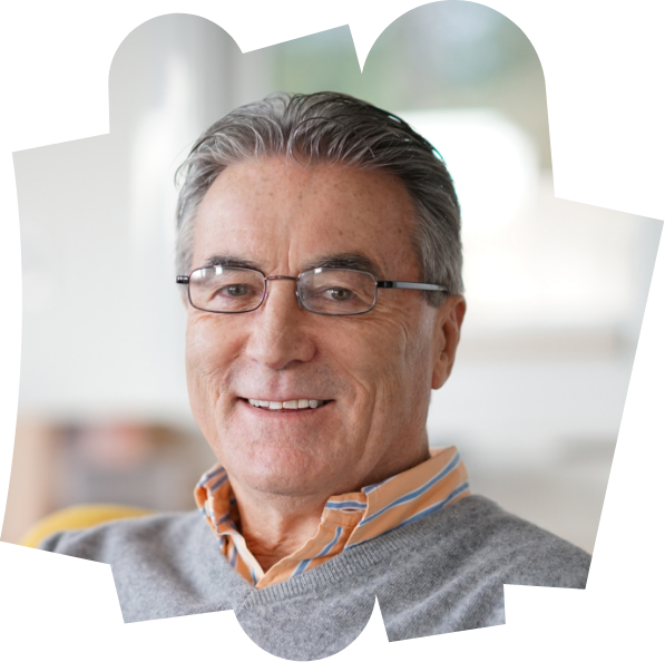 An eldery man wearing glasses smiling